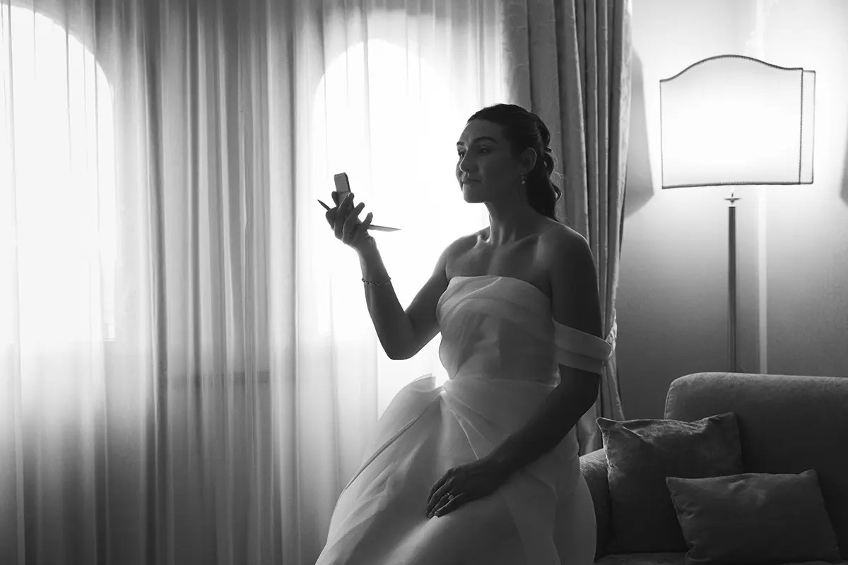 Bride looks at herself in the mirror