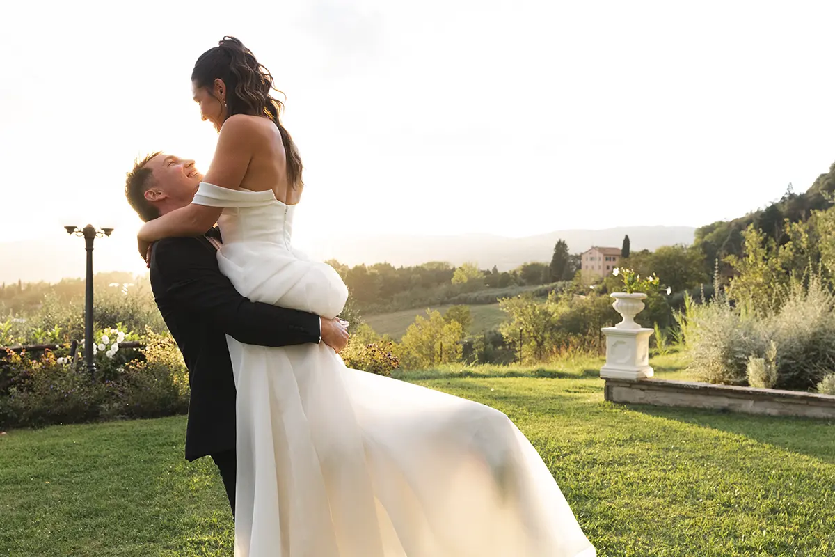 Newlyweds at sunset joke and play with each other