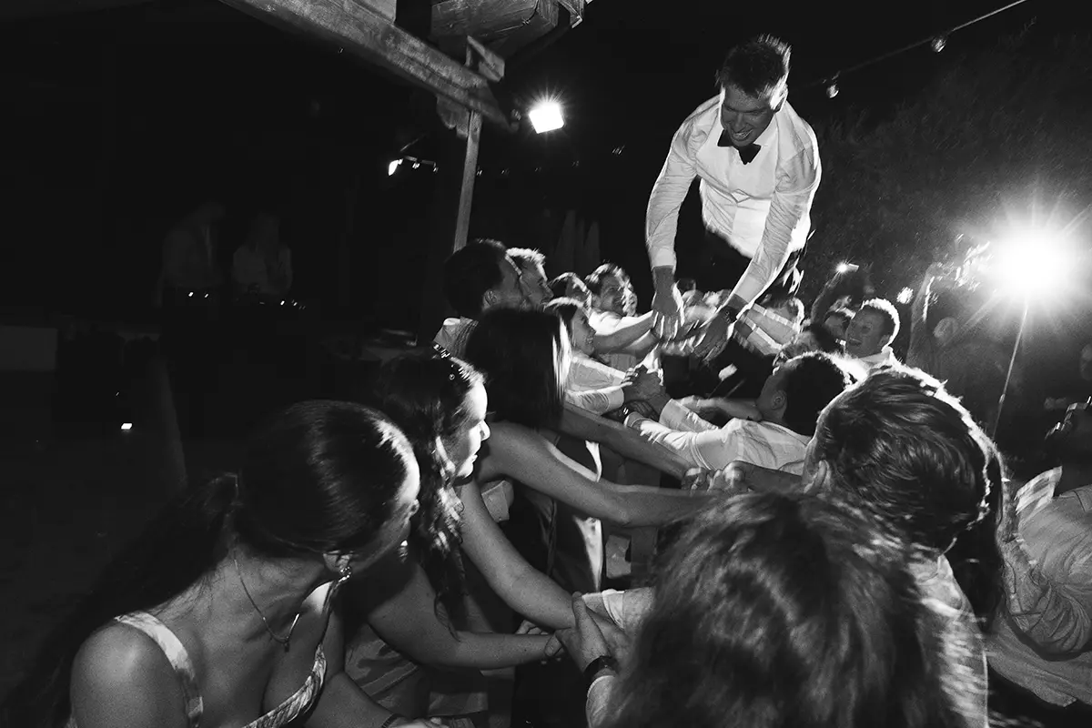 The groom is thrown into the air by his friends