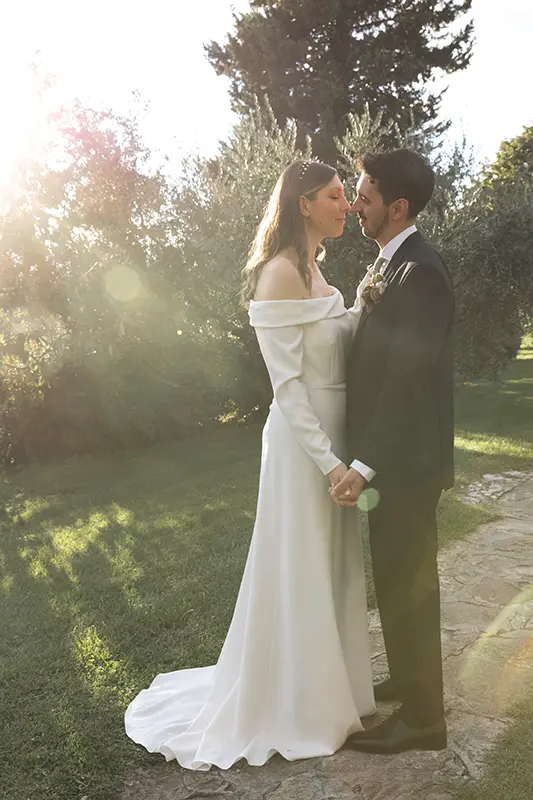 Newlyweds embrace in a Tuscan garden