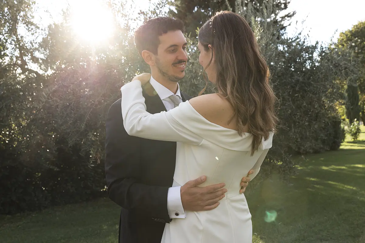 Newlyweds embrace while smiling