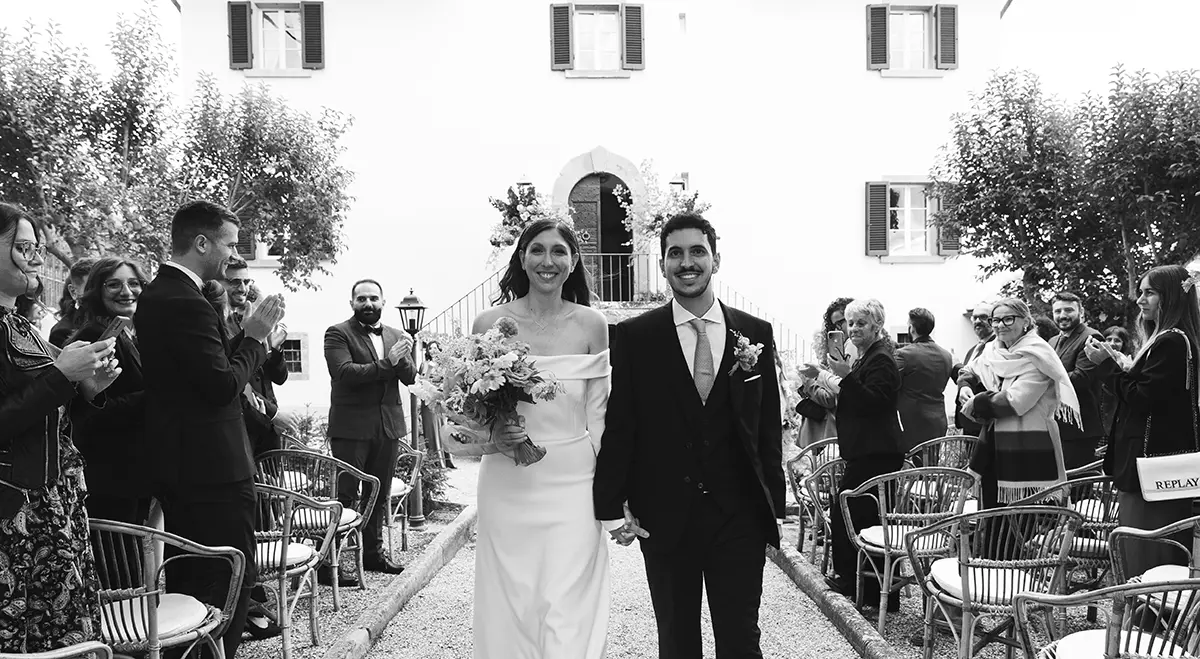 Smiling newlyweds exit at the end of the ceremony