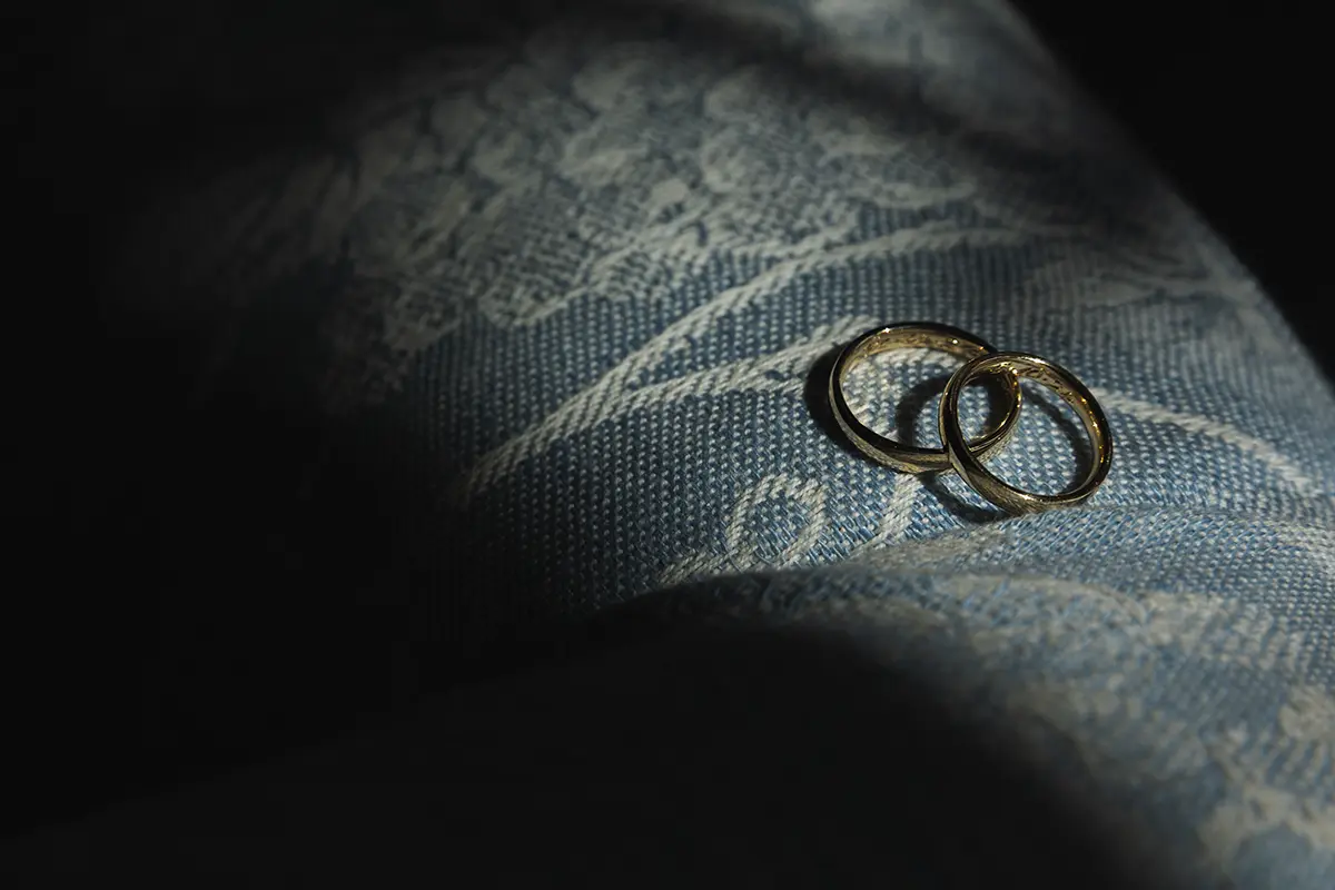 Wedding rings on blue fabric