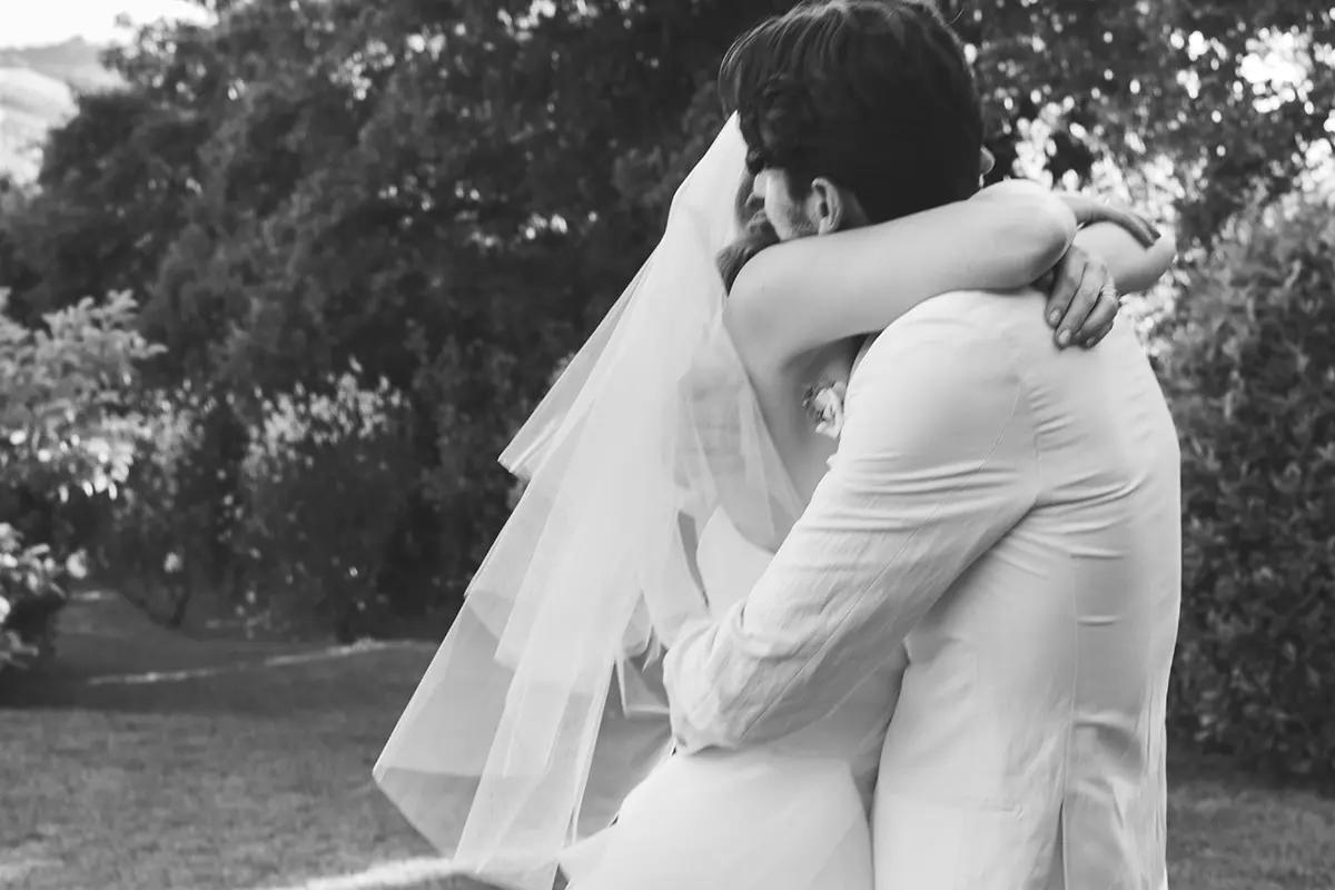 Spouses embrace each other