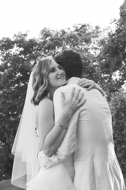 Spouses embrace each other