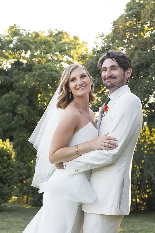 Newlyweds embrace while smiling