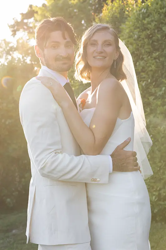 Newlyweds embrace at sunset