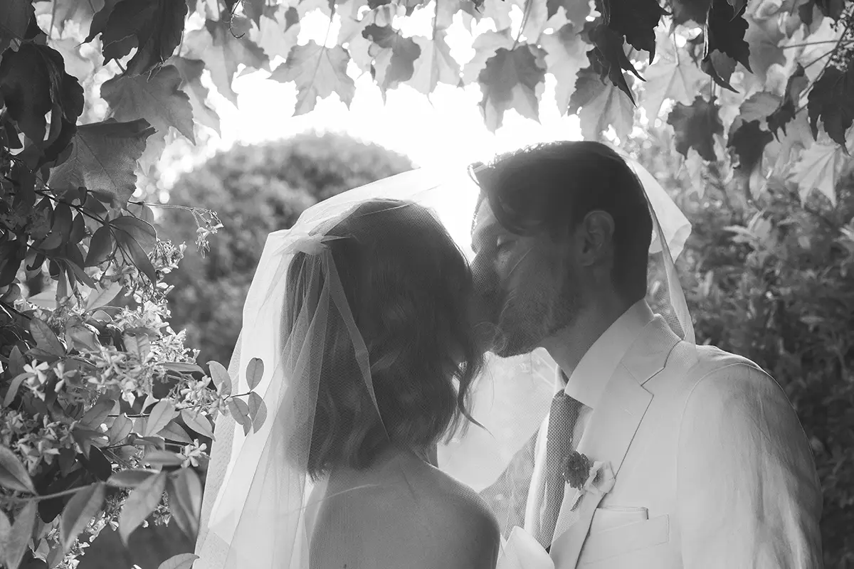 Newlyweds kiss under the veil