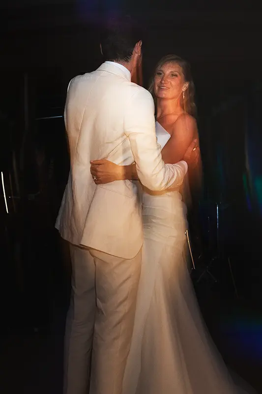 The bride smiles as she dances with her groom