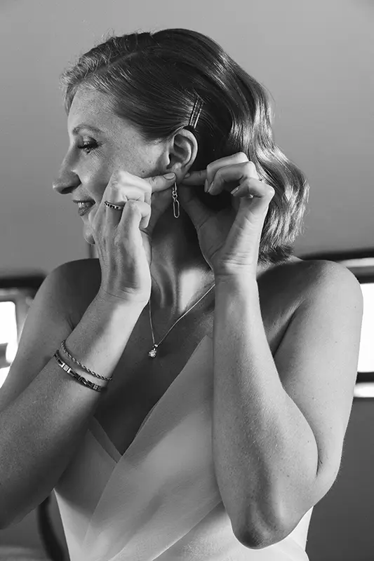 Bride puts on earrings